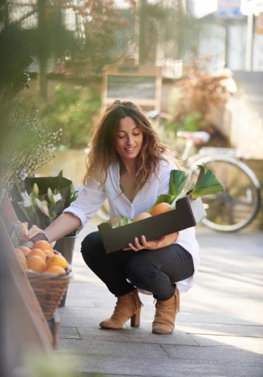 Woman picking fruit at a market